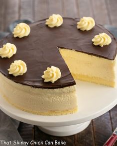 a chocolate and vanilla cheesecake on a white cake plate