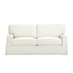 a white couch sitting on top of a white floor