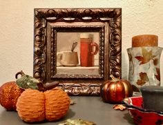 a table topped with lots of different types of vases and other decorative items next to a mirror