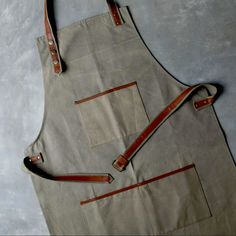 Dimensions: 39 1/2" X 25" Handmade One Size Fits All. Adjustable Brass Snaps. This Product Is Currently Sold Out On Magnolia’s Website. “Our Canvas And Leather Apron Is A Handmade Apron Made Of Leather And Canvas. This High Quality Apron Makes An Ideal Gift For Any Craftsman, Handyman, Or Grill Master. Its Adjustable Brass Snaps Make It One Size Fits Most.” We Bought Too Many Of These For Our Business So We Are Selling Them Here For A Discounted Price! Couture, Patchwork, Apron Pattern Free, Handmade Apron, Sewing Decor, Cottagecore Kitchen, Woodworking Apron, Diy Apron, Apron Pattern