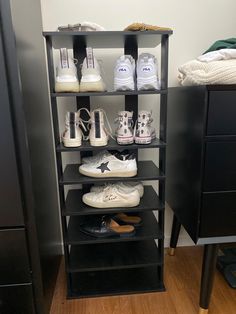 there are many pairs of shoes that are on the shelf next to each other in this room