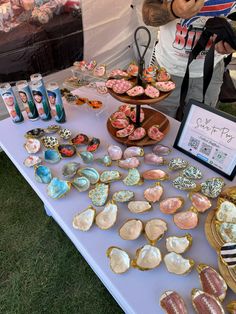 a table topped with lots of assorted cookies and pastries on top of it