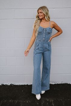 DOORBUSTERS EXCLUDED FROM DISCOUNT CODES Elevate your wardrobe with our new Dally Denim Jumpsuit. The adjustable straps provide a customizable fit, while the bustier style top and button accents add a touch of chic. With a convenient side zipper closure, this jumpsuit effortlessly combines style and functionality! 90% cotton, 10% polyester Inseam: 31" Model is 5'6" with a 34" bust, 27" waist, and 36" hips and wearing a small. Size recs: S 2-4 M 4-6 L 8-10 Denim Pants Romper, Loungewear Summer, Pants Romper, Shoes Sandals Heels, Dresses By Length, Denim Jumpsuit, Short Rompers, Top Sales, Skirt Pants