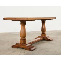 a wooden table with two legs on concrete floor