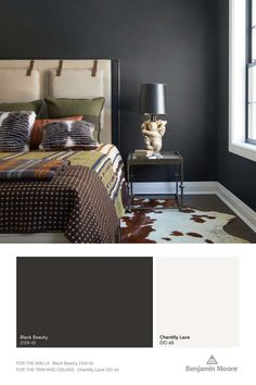 the bedroom is painted in dark gray and has brown accents, including a cowhide rug