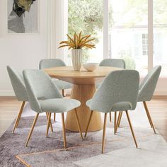 a dining room table with six chairs around it