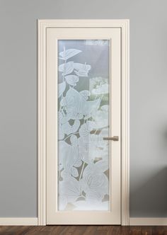 an open door with frosted glass on the front and side panels, in a gray room