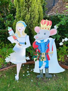 two paper cutouts of mice dressed as princess and prince standing next to each other