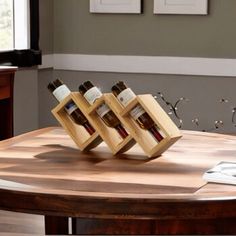 three bottles of wine are sitting on a wooden table in the middle of a living room