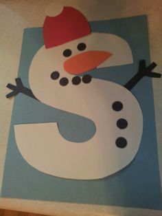 a paper cut out of a snowman with a red hat on it's head