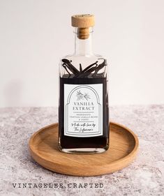 a bottle of vanilla syrup sitting on top of a wooden tray