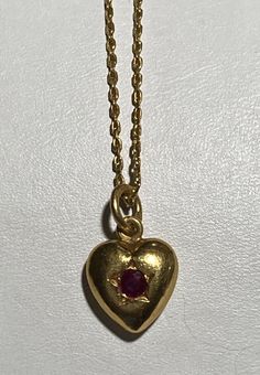 Vintage 22K Yellow Gold Chain With 22K Gold Heart Ruby Pendant Necklace 17 Inches long And 1 mm wide. The heard pendant is about 3/4 inches long and 12 mm wide、 Ruby is about 0.20 cttw. Weight is 5.6g. Photos are part of the description. Please take a look at the pictures for more details. Mark 96% {22k} The head of the necklace clasp is missing a little. Please take a look at the last pictures for more details. The other side of the heart pendant is engraved with flower。 Photos are part of the Ruby Pendant Necklace, Ruby Necklace Pendant, Necklace Clasp, Necklace Clasps, Ruby Pendant, Yellow Gold Chain, Flower Photos, Gold Heart, 22k Gold