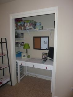 a room with a desk and shelves in it