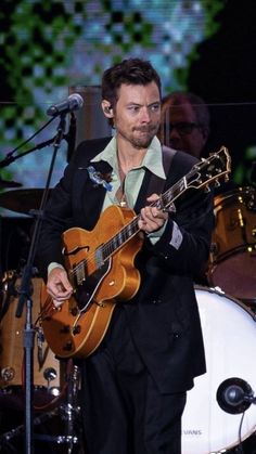 a man playing an electric guitar on stage