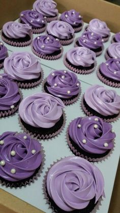 purple cupcakes in a box with pearls on them