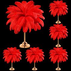 red feathers are placed on top of each other in the shape of an umbrella and stand