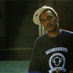 a man wearing a white hat and black shirt