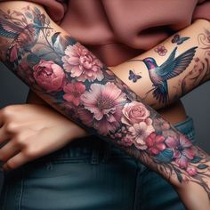 a woman's arm covered in tattoos with flowers and hummings on her arm