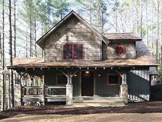 a house in the woods with red windows