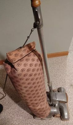 a bag sitting on the floor next to a vacuum