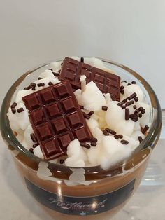 a bowl filled with chocolate and marshmallows on top of a table