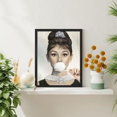 a painting of a woman with a bubble in her mouth on a shelf next to potted plants