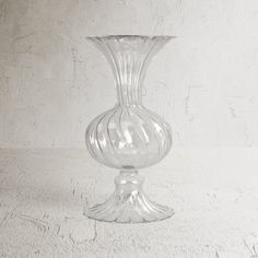 a clear glass vase sitting on top of a table