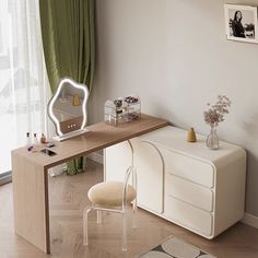 a room with a desk, chair and pictures hanging on the wall above it in front of a window