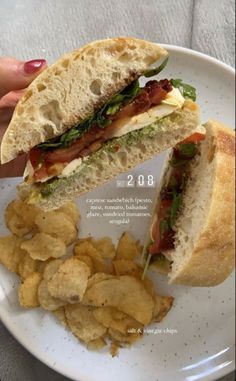 a sandwich and potato chips on a plate with the caption'lunch time '