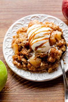 an apple crisp with ice cream and caramel drizzled on the top