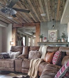 a living room filled with furniture and a ceiling fan