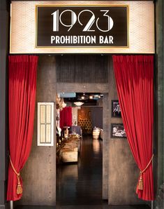 an entrance to a bar with red curtains