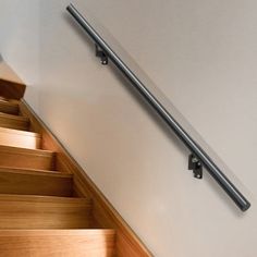 a stair rail on the side of a wooden staircase