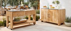 an outdoor dining area with wooden furniture and potted plants