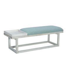 a white bench with a blue cushion sitting on it's backrest and side table