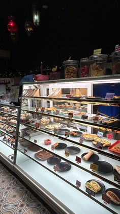 a display case filled with lots of different types of food and desserts on it