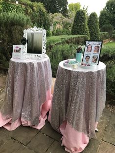 two round tables covered in pink and silver sequins with pictures on the table