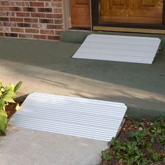 two white steps sitting on the side of a building