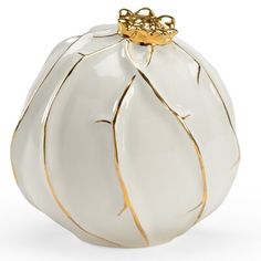 a white vase with gold trimmings on it