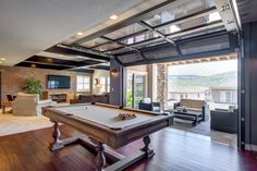 a pool table in the middle of a living room