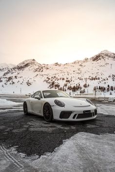 a white sports car parked in the snow