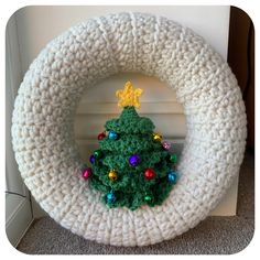 a crocheted wreath with a christmas tree on it