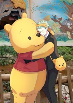 two people hugging each other in front of a cartoon wall with an image of winnie the pooh on it