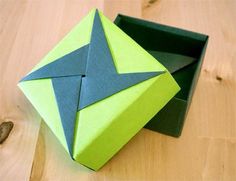 an origami box sitting on top of a wooden table