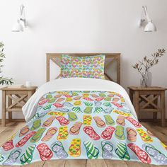 a bed covered in a colorful comforter and pillows