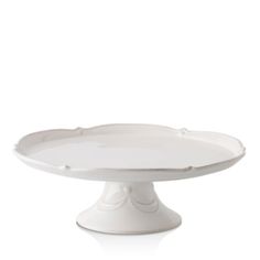 a white cake plate sitting on top of a table