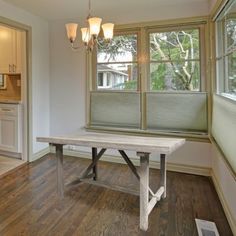 an empty kitchen and dining room with wood flooring is pictured in this image from the inside