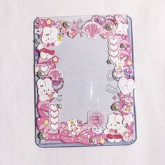 a mirror with hello kitty decorations on it