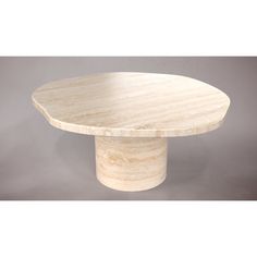 a round marble table on a grey background