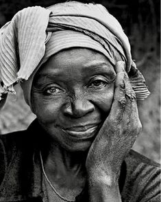 a black and white photo of a woman with a turban on her head